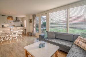 a living room with a couch and a table at Vredelust 57 in De Koog