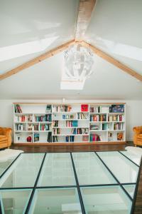 a glass floor in a room with bookshelves at Chalet 2B in Cavnic