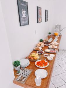 a long table filled with food and plates of food at Nacional Park Hotel Lages in Lages