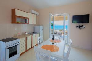 a kitchen with a table and a dining room with the ocean at Manda 107 Mansion in Budva