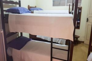 a couple of bunk beds in a room at Pousada Marraial in Arraial d'Ajuda