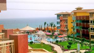 a view of a resort with a pool and the ocean at Sun studios in porto south beach families only in Ain Sokhna