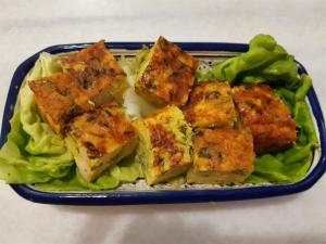 a blue plate of food with tofu on lettuce at Dar Chick Yahia Ile De Djerba in Mezrane