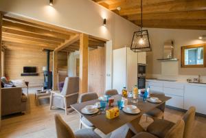 a kitchen and living room with a table and chairs at Les Portes de Megève in Praz-sur-Arly