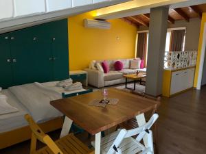 a living room with a table and a couch at Guest House People in Korçë
