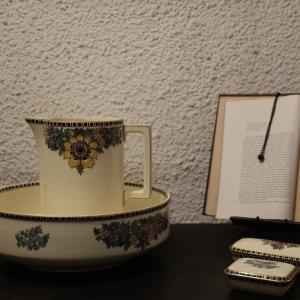 a tea cup sitting on a table next to a book at Hotel Portofoz in Porto