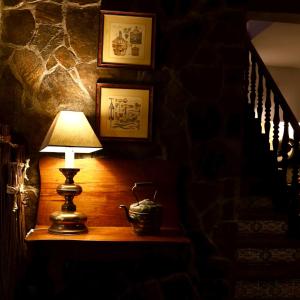 a lamp sitting on a table next to a staircase at Hotel Portofoz in Porto