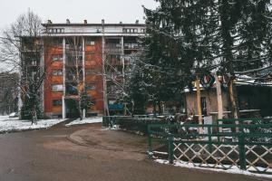 a building with a green bench in front of it at M&Stic in Vrdnik