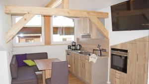 a kitchen and living room with a table and a sink at Apartment Fleißner in Dienten am Hochkönig