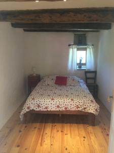 a bedroom with a bed with a wooden floor at Aveyron West in Saint-Igest