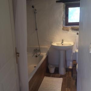 a bathroom with a sink and a toilet and a tub and a sink at Aveyron West in Saint-Igest