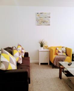 a living room with two couches and a table at Sigma Central Apartment 2 in North Shields