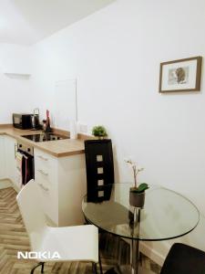a small kitchen with a glass table in a room at Sigma Central Apartment 2 in North Shields