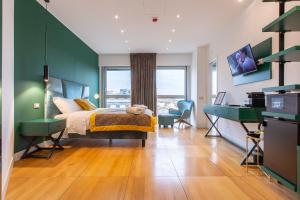 a bedroom with a bed and a desk at Missori Suites in Milan +37 photos