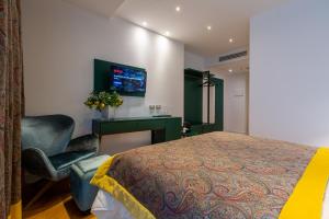 a bedroom with a bed and a desk and a chair at Missori Suites in Milan