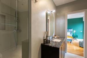 a bathroom with a sink and a mirror at Missori Suites in Milan