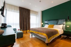a bedroom with a bed and a green wall at Missori Suites in Milan
