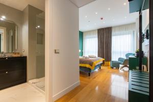 a bedroom with a bed and a living room at Missori Suites in Milan