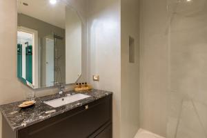 a bathroom with a sink and a mirror at Missori Suites in Milan