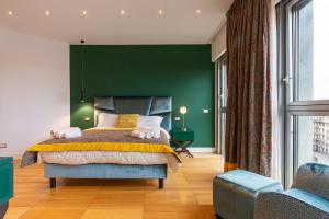 a bedroom with a green wall and a bed at Missori Suites in Milan