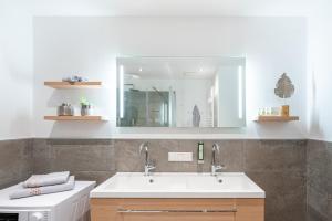a bathroom with a sink and a mirror at LakeSide Appartments in Goldegg
