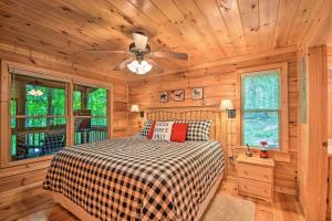 a bedroom with a bed and a ceiling fan at Pinot and Pine Chic Log Cabin about 5 Mi to Blue Ridge in Blue Ridge