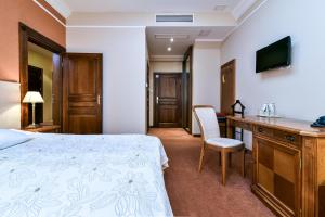 Postel nebo postele na pokoji v ubytování Hotel SPA Wieniawa