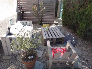 a patio with two chairs and a bench and a plant at Studio Alpins in Annecy