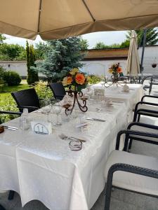 a group of tables with white table cloths at Casa Jasmine in Braşov