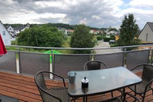 a table and chairs on a balcony with a view at Ferienwohnung Anemone in Bahlingen