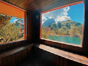 a window in a room with a view of a mountain at Ecolodge Bahia del Peñón in Guatapé