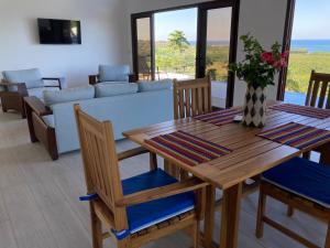 a dining room with a table and a couch at Turquoise Views at Coral Views Village in French Harbour