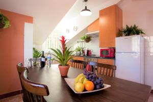 a kitchen with a table with a plate of fruit on it at Contador Mor Rooms and Apartments in Lisbon +84 photos