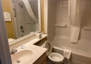 a bathroom with a sink and a toilet and a shower at Ocean Club Resort Myrtle Beach a Ramada by Wyndham in Myrtle Beach