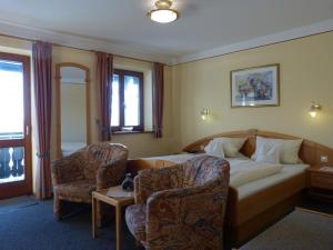 a hotel room with a bed and a chair at Giglerhof in Bad Birnbach