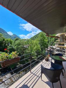a balcony with a view of the mountains at Hotel Holiday Maria in Băile Herculane