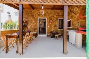 a kitchen and dining room with a table and chairs at Hara's Traditional Detached House in Malona in Malona Village