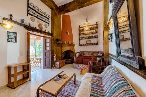 a living room with a couch and a fireplace at Hara's Traditional Detached House in Malona in Malona Village