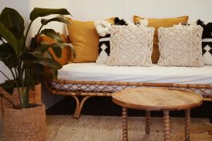 a couch with pillows and a table in a room at Hotel La Chaumette in Privas +21 photos