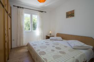 Posteľ alebo postele v izbe v ubytovaní Seafront Apartment Dana