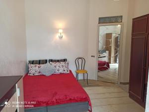 1 dormitorio con cama roja, mesa y silla en Студия у моря, терасса, отдельный вход en Odesa