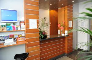 a lobby with a waiting room with a mirror at Central-Classic Hotel in Stuttgart