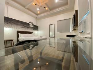 a room with a bed and a glass table at Pembroke Inn in Toronto