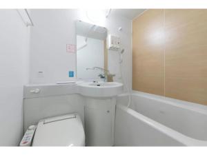 a bathroom with a sink and a toilet and a mirror at R&B Hotel Shin Osaka Kitaguchi - Vacation STAY 15205v in Osaka +19 photos