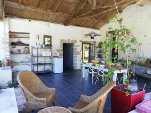 a kitchen with a table and chairs in a room at Au Logis de la Mongie in Soullans