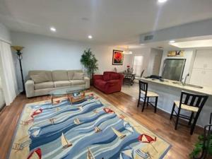 a living room with a large rug with boats on it at Florida Condos on Lake Tarpon in Palm Harbor
