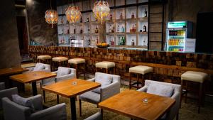 a restaurant with tables and chairs and a bar at Riverside Boutique Hotel in Bansko