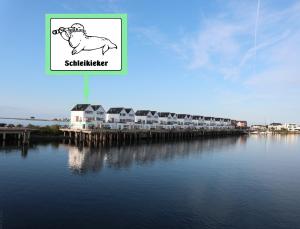 a drawing of a cow on the side of a body of water at Schleikieker Maisonette in Olpenitz