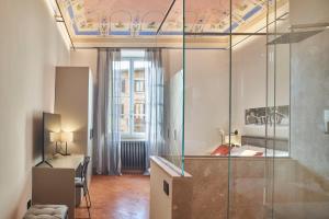 a room with a desk and a glass wall at Residenza d'epoca San Martino 29 in Siena +19 photos