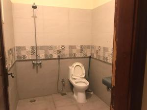 a bathroom with a toilet in a stall at King's Paradise in Lahore
